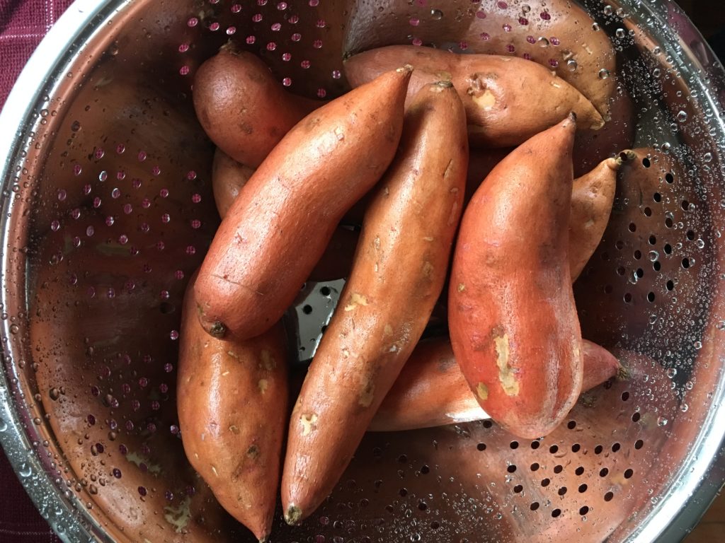 Overhead shot of washed potatoes in a colander