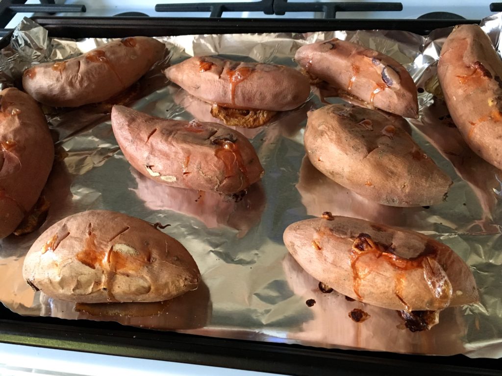 Close-up shot of roasted sweet potatoes on a sheet pan