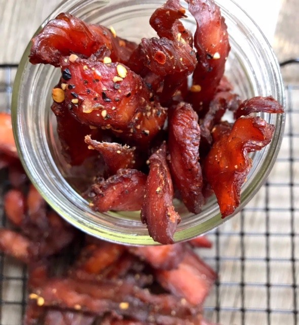 Close-up overhead view of a glass jar full of turkey jerky 