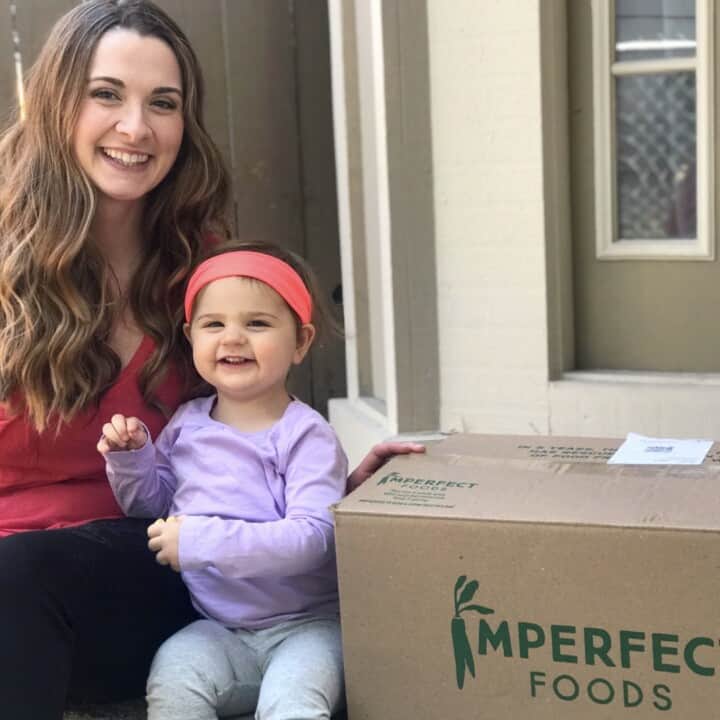 Woman and daughter sitting next to an Imperfect Foods delivery box