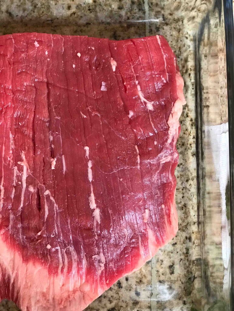 Overhead shot of a cut of raw flank steak