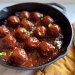 Side shot of Baked BBQ Beef Meatballs in a skillet