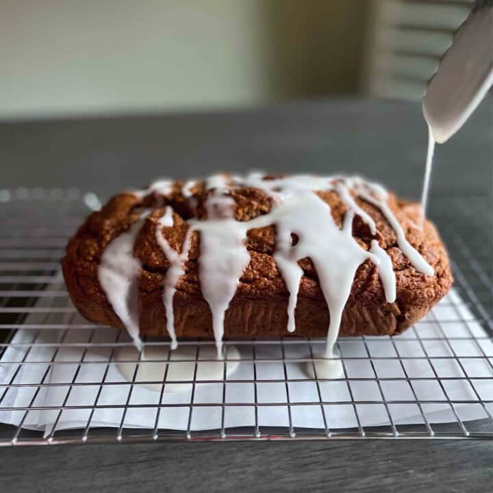 Side shot of Pumpkin Gingerbread getting icing drizzle