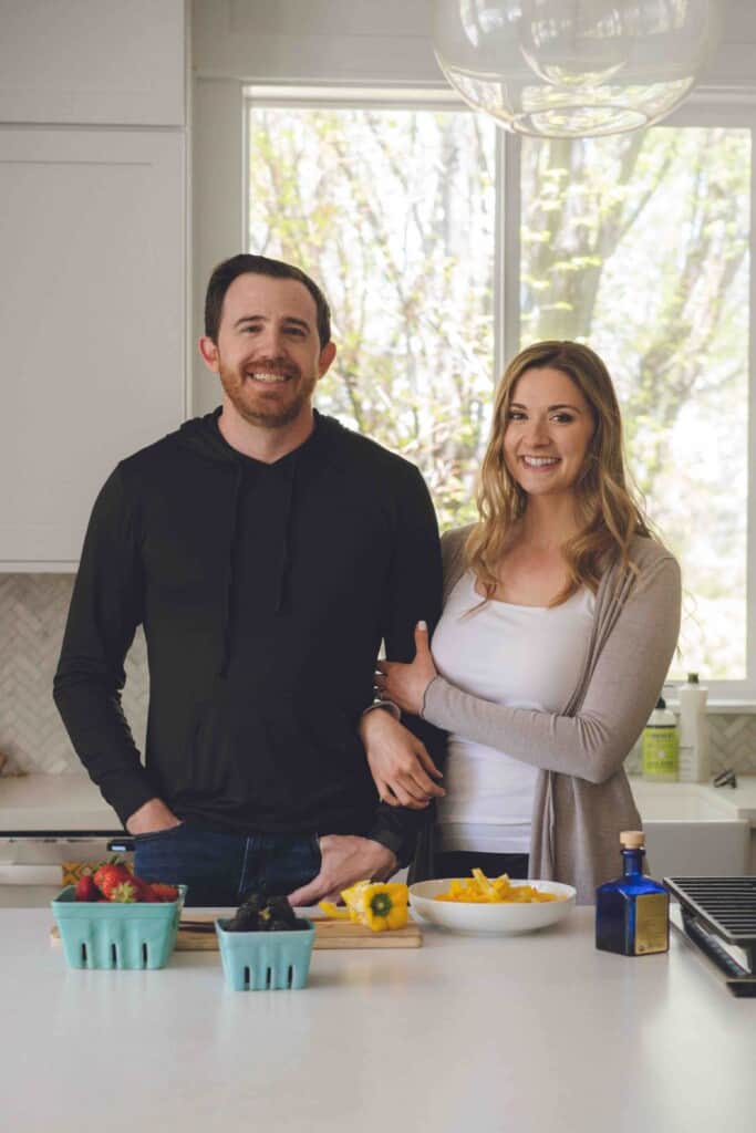 Shot of couple standing arm in arm in kitchen